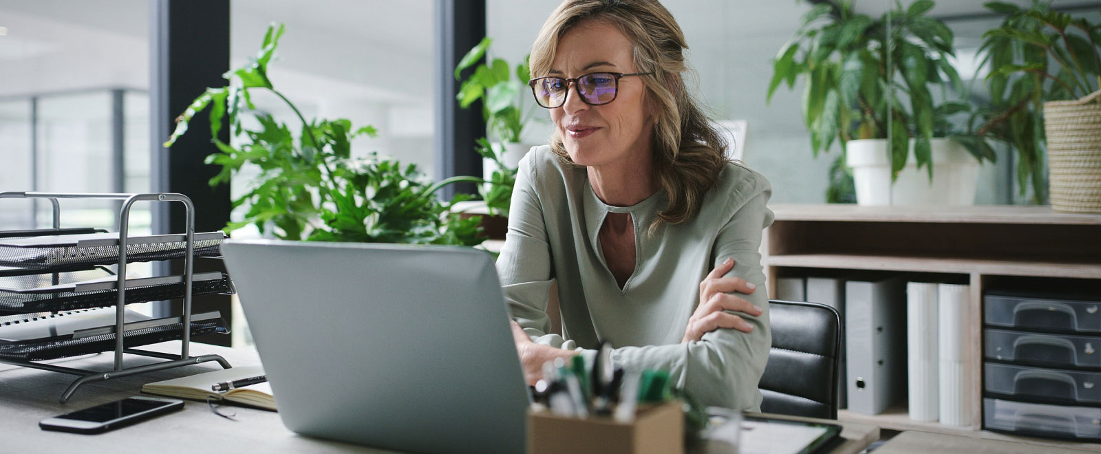 woman using a laptop in a modern office