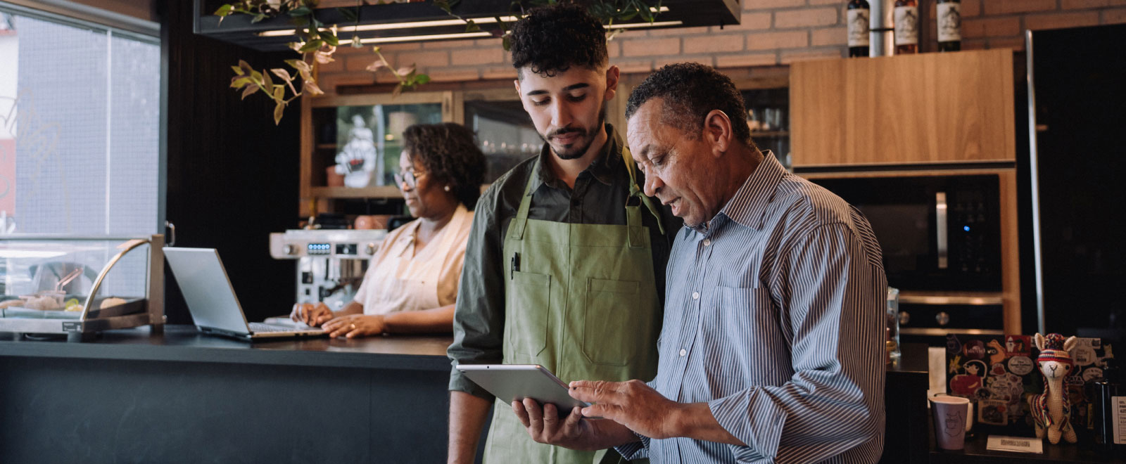 three people working in a cafe